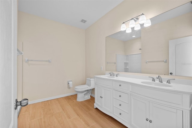 bathroom with walk in shower, wood-type flooring, vanity, and toilet