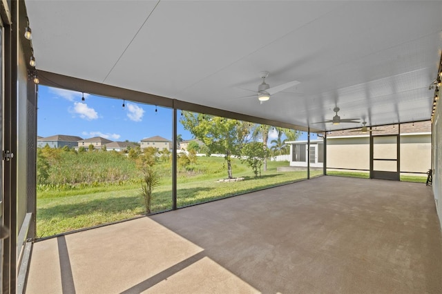 unfurnished sunroom featuring ceiling fan