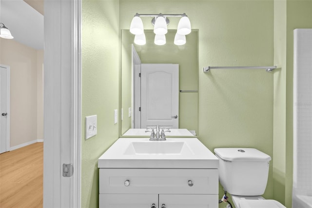 bathroom with hardwood / wood-style floors, vanity, and toilet