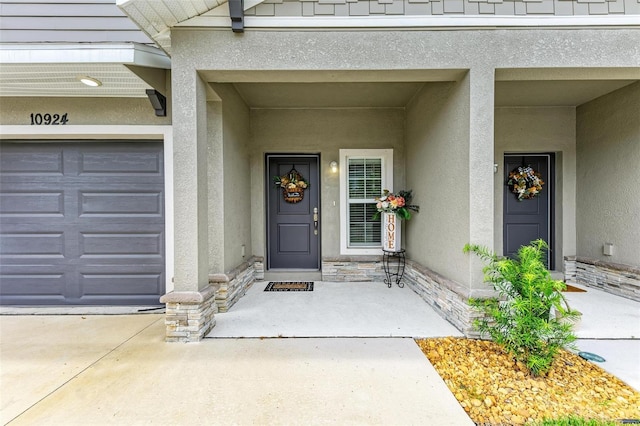 view of exterior entry featuring a garage