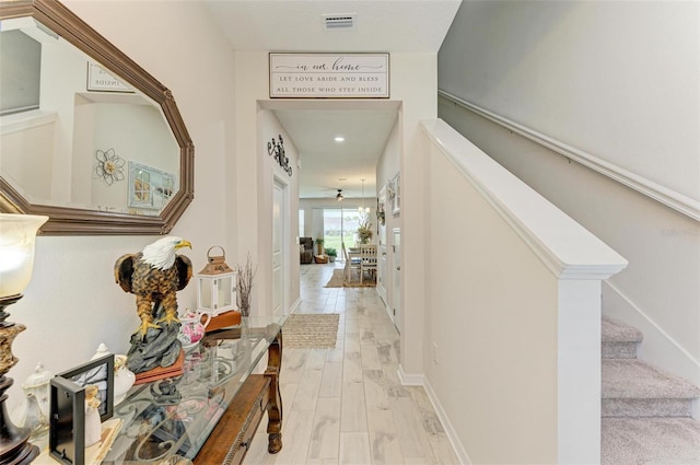 hallway with light hardwood / wood-style floors