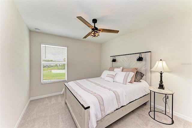 bedroom with ceiling fan and light colored carpet