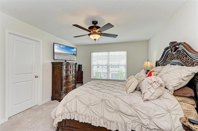 bedroom with carpet, ceiling fan, and a textured ceiling