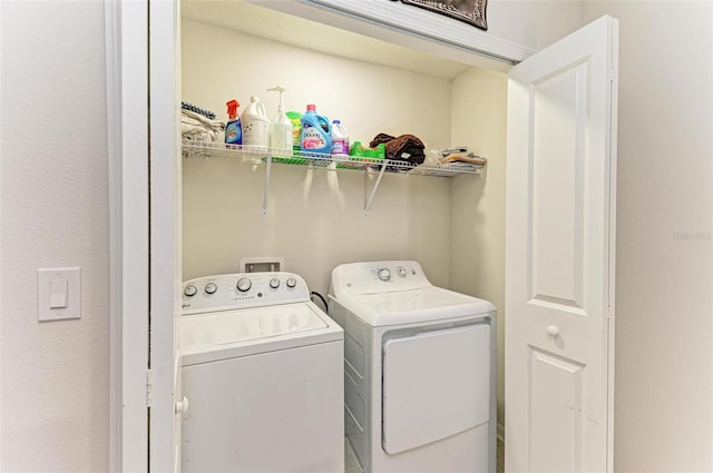 clothes washing area with separate washer and dryer