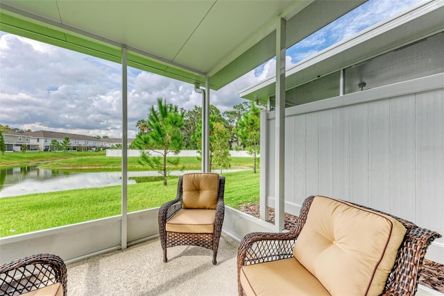 sunroom / solarium featuring a water view and plenty of natural light