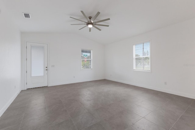 tiled spare room with ceiling fan and vaulted ceiling