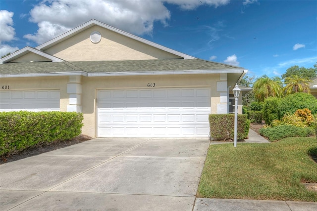 view of front of house featuring a garage and a front lawn