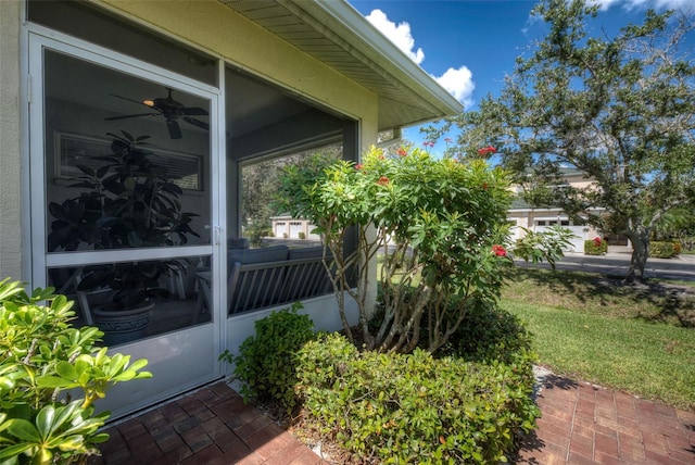 view of side of home featuring ceiling fan