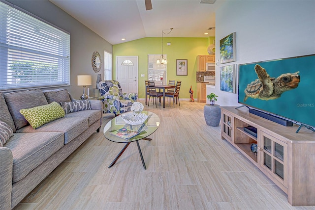 living room with vaulted ceiling and an inviting chandelier