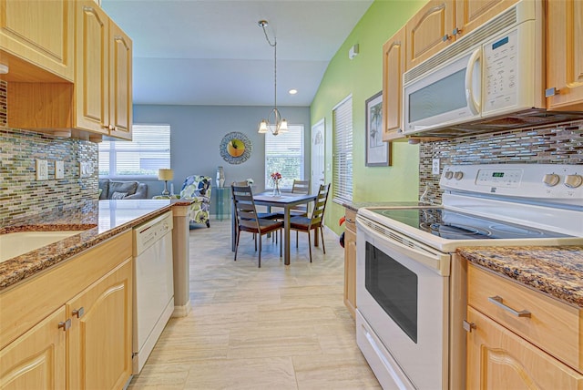 kitchen with decorative backsplash, pendant lighting, white appliances, a notable chandelier, and lofted ceiling