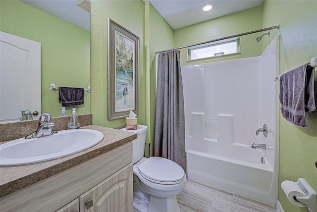 full bathroom featuring wood-type flooring, shower / bath combo, vanity, and toilet