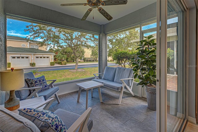 sunroom featuring ceiling fan and plenty of natural light