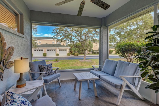 sunroom / solarium featuring ceiling fan