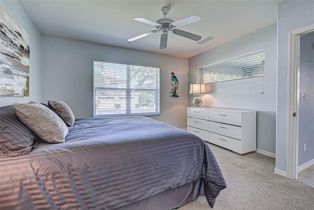 bedroom featuring light carpet and ceiling fan