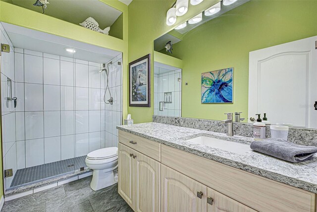 bathroom featuring walk in shower, vanity, and toilet