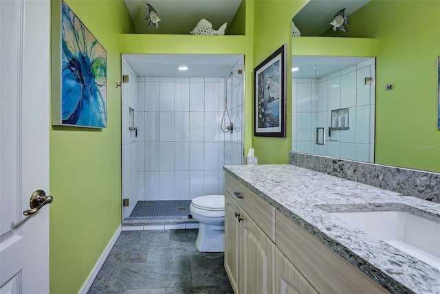 bathroom featuring an enclosed shower, vanity, and toilet