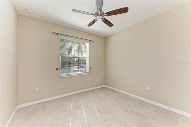 empty room with light tile patterned floors and ceiling fan