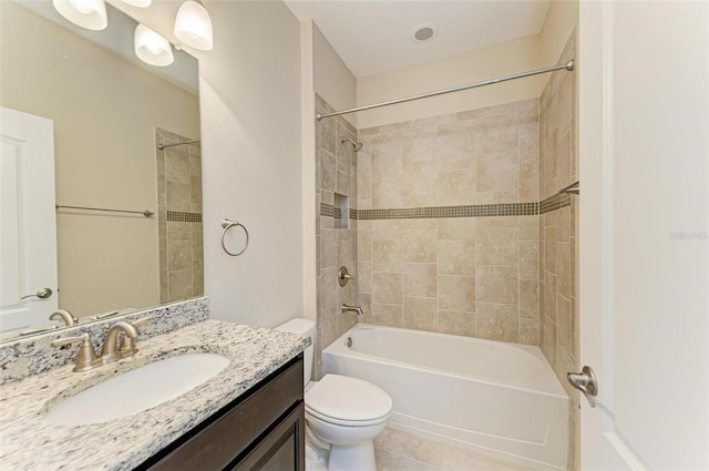 full bathroom with toilet, tiled shower / bath combo, vanity, and tile patterned floors