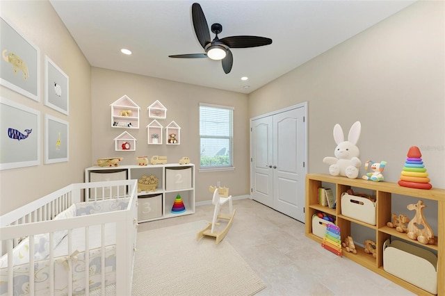 bedroom with a closet, a crib, and ceiling fan