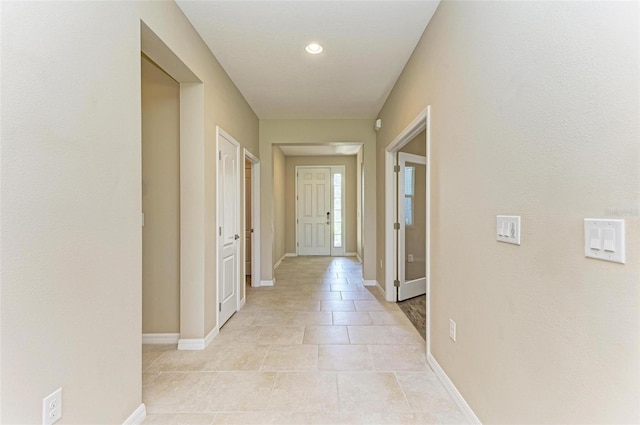 corridor featuring light tile patterned floors