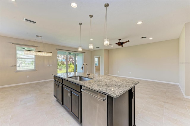 kitchen featuring light stone countertops, sink, an island with sink, ceiling fan, and stainless steel dishwasher