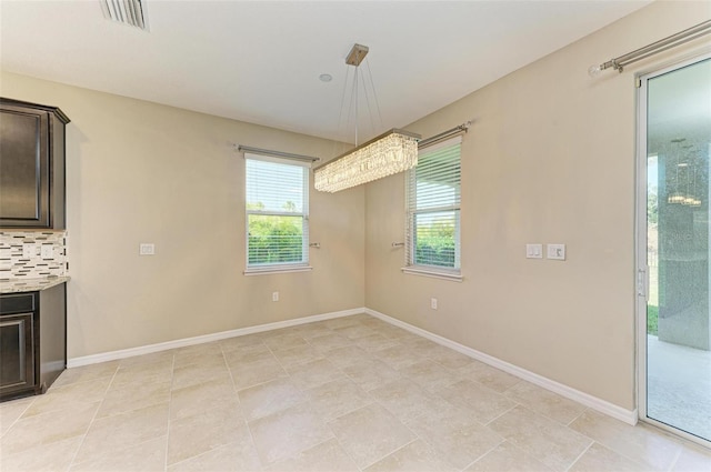 unfurnished dining area featuring light tile patterned floors