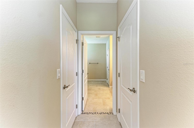 hall featuring light tile patterned floors