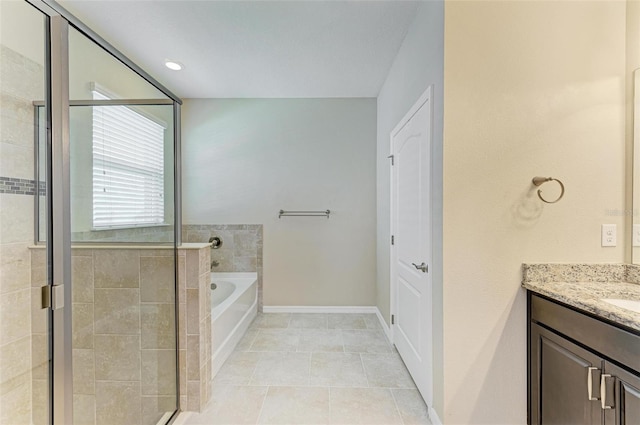 bathroom featuring vanity, shower with separate bathtub, and tile patterned flooring