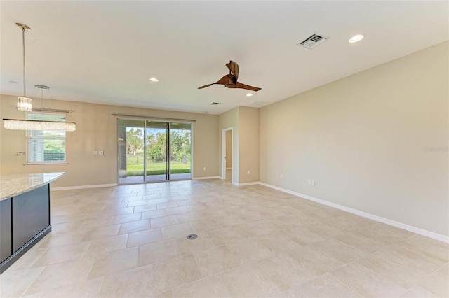 unfurnished living room with ceiling fan and light tile patterned floors