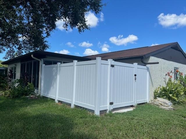 view of outbuilding with a lawn