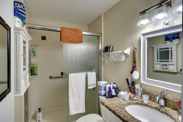 bathroom with vanity, toilet, and an enclosed shower