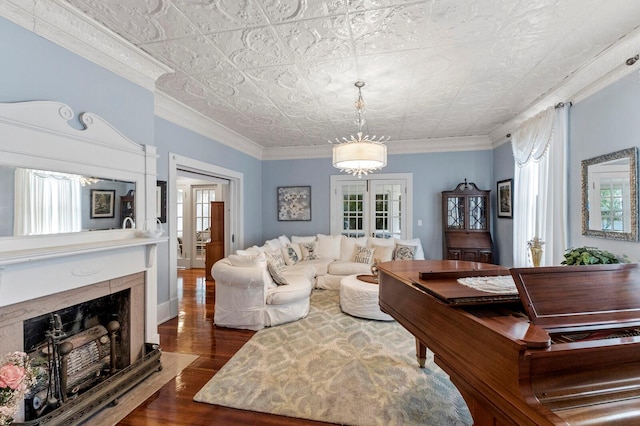 living room featuring ornamental molding, a premium fireplace, dark hardwood / wood-style floors, and a wealth of natural light