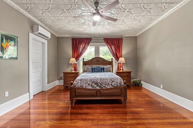 bedroom with ornamental molding, ceiling fan, hardwood / wood-style flooring, and a wall mounted AC