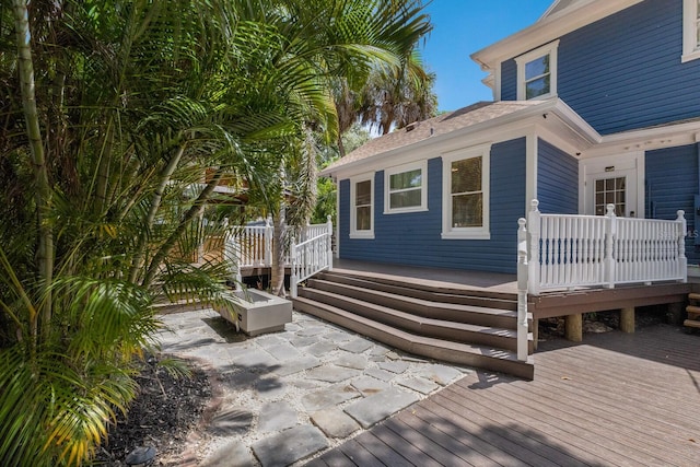 exterior space with a wooden deck and a patio