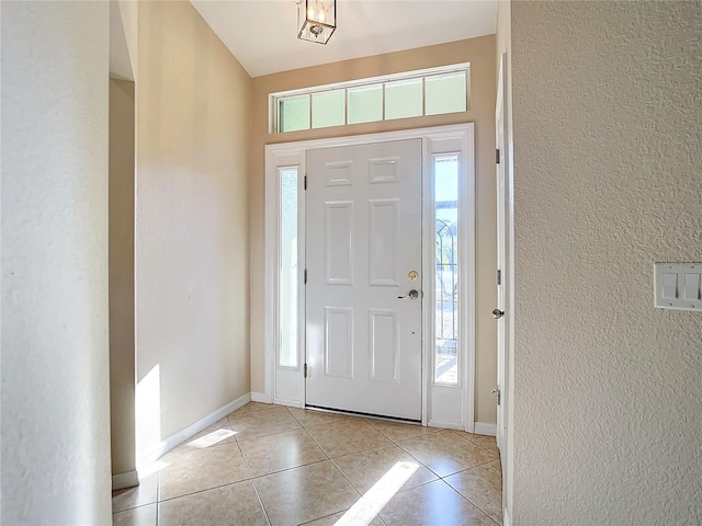 tiled foyer featuring plenty of natural light