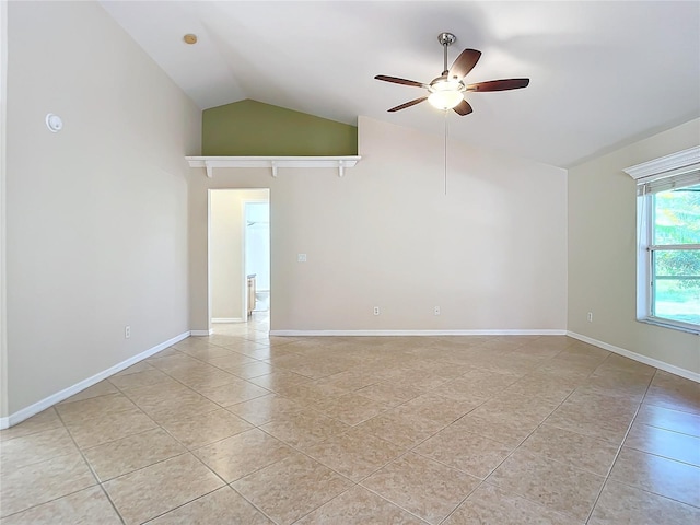 unfurnished room with lofted ceiling, ceiling fan, and light tile patterned flooring