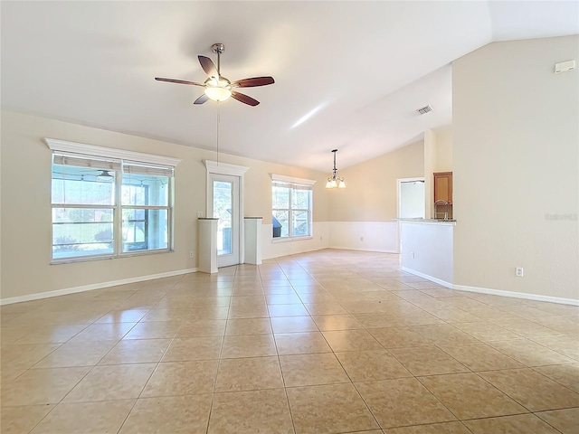 unfurnished living room with light tile patterned flooring, ceiling fan with notable chandelier, and lofted ceiling