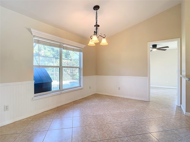 tiled empty room with ceiling fan with notable chandelier and lofted ceiling