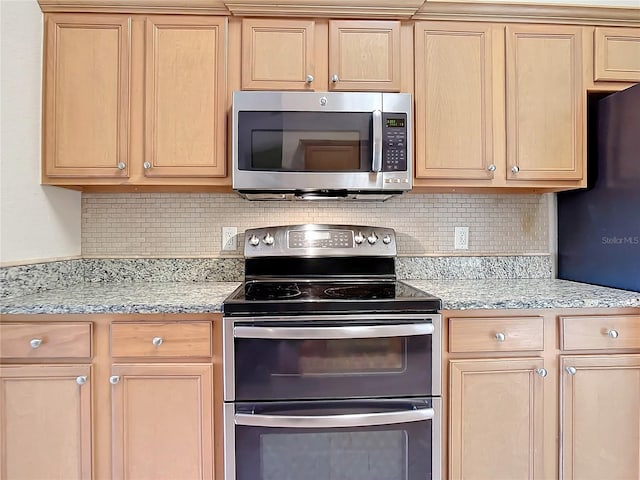 kitchen with light brown cabinetry, appliances with stainless steel finishes, and tasteful backsplash