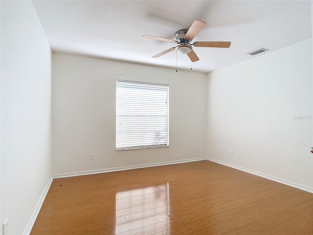 spare room featuring wood-type flooring and ceiling fan