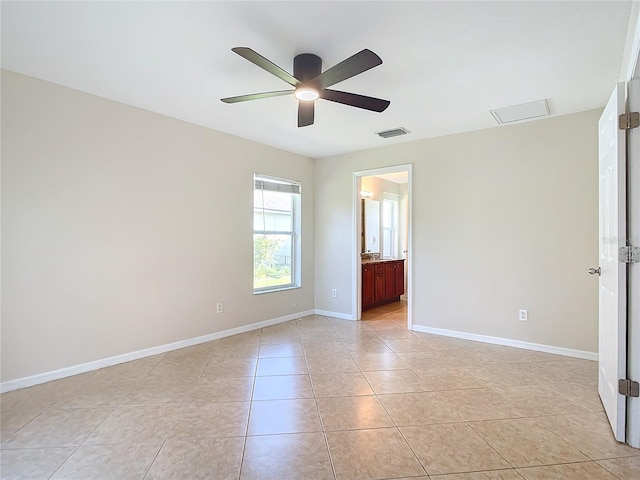 tiled spare room featuring ceiling fan