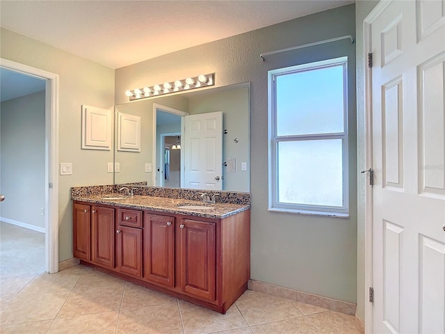 bathroom featuring tile patterned flooring and vanity