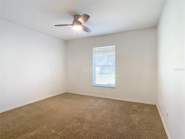 carpeted empty room featuring ceiling fan