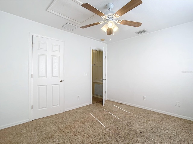 carpeted spare room featuring ceiling fan