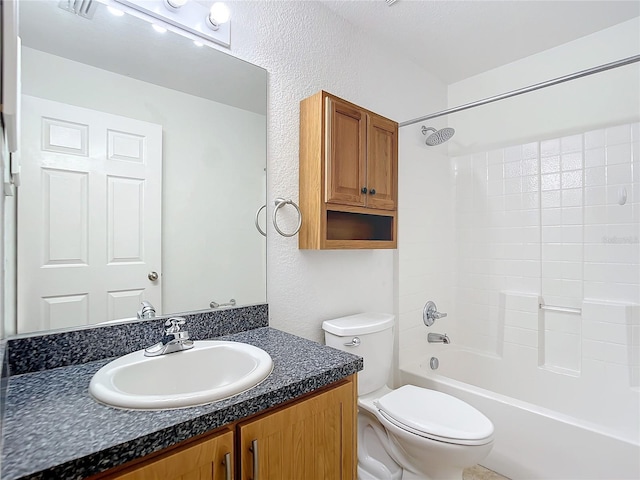 full bathroom with  shower combination, vanity, and toilet