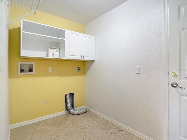 laundry room featuring hookup for a washing machine, cabinets, light tile patterned floors, and electric dryer hookup