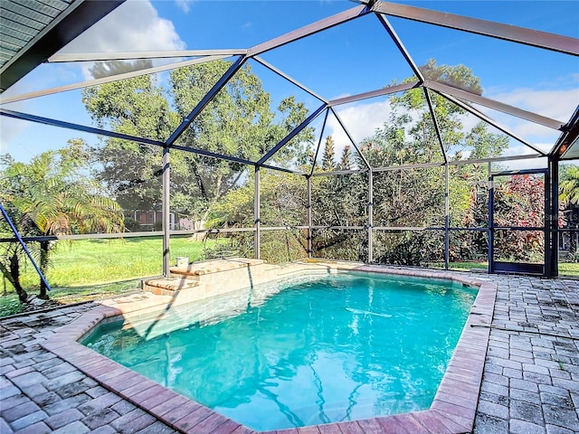 view of swimming pool with a yard, a lanai, and a patio area