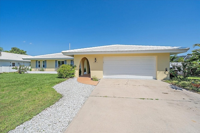 single story home featuring a front lawn and a garage