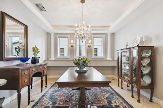 dining area with light tile patterned floors, a notable chandelier, a tray ceiling, and ornamental molding