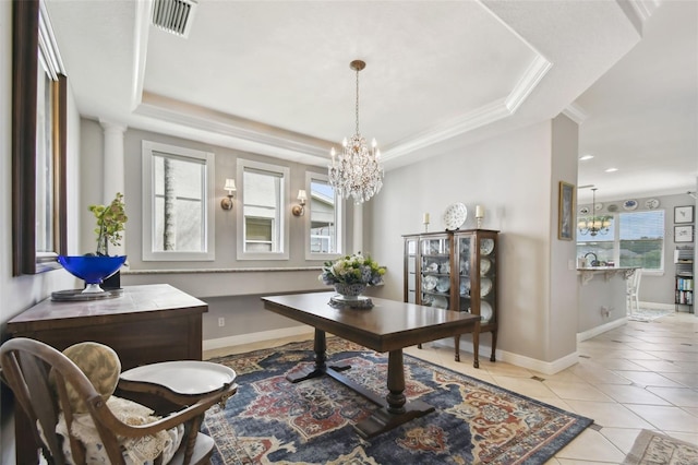 office featuring a chandelier, a raised ceiling, light tile patterned flooring, and crown molding